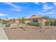 Attractive single-story home with desert landscaping and a well manicured lawn at 8420 W Cherry Hills Dr, Peoria, AZ 85345