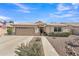 Inviting single-story home with a well-manicured front yard, neutral tones, and a convenient two-car garage at 8420 W Cherry Hills Dr, Peoria, AZ 85345