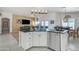 Stylish kitchen island with granite counters and stainless steel dishwasher, adjacent to living area at 8420 W Cherry Hills Dr, Peoria, AZ 85345