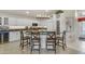 Modern kitchen island with seating, granite countertops, white cabinets, and stainless steel appliances at 8420 W Cherry Hills Dr, Peoria, AZ 85345