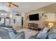 Cozy living room with a TV, tile flooring, neutral paint and easy access to entryway at 8420 W Cherry Hills Dr, Peoria, AZ 85345