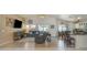 Open-concept living space featuring tile floors, vaulted ceilings, and a seamless transition to the dining area at 8420 W Cherry Hills Dr, Peoria, AZ 85345
