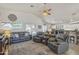 Spacious living room with comfortable seating and ample natural light, flowing into kitchen and dining areas at 8420 W Cherry Hills Dr, Peoria, AZ 85345