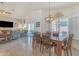 Open floor plan with a dining area leading to a living room with sliding doors and a TV at 8420 W Cherry Hills Dr, Peoria, AZ 85345
