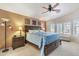Spacious main bedroom with ceiling fan, accent wall, and natural light from shuttered windows at 8420 W Cherry Hills Dr, Peoria, AZ 85345
