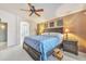 Large main bedroom with accent wall, fan, and ensuite bathroom with glass enclosed shower at 8420 W Cherry Hills Dr, Peoria, AZ 85345