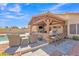 Spacious covered patio with an outdoor kitchen and bar seating area at 8420 W Cherry Hills Dr, Peoria, AZ 85345