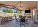 Entertainer's patio featuring a dining area, fireplace, outdoor kitchen, and stunning pool views at 8420 W Cherry Hills Dr, Peoria, AZ 85345