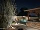 Backyard pool area with accent lighting and a covered outdoor kitchen at 8420 W Cherry Hills Dr, Peoria, AZ 85345