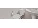 Bathroom featuring a pedestal sink and toilet with a clean, minimalist design at 9733 E Axle Ave, Mesa, AZ 85212