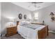 This bedroom has neutral walls, carpet flooring, and a wooden bed frame at 9733 E Axle Ave, Mesa, AZ 85212