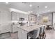 Gourmet kitchen featuring a large island with seating, gray cabinetry, and an adjacent dining area at 9733 E Axle Ave, Mesa, AZ 85212
