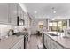Open concept kitchen with gray cabinets, stainless steel appliances, island seating, and view of the backyard at 9733 E Axle Ave, Mesa, AZ 85212