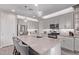 Stylish kitchen with gray cabinets, stainless steel appliances, large island, and pendant lighting at 9733 E Axle Ave, Mesa, AZ 85212