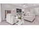 A bright living room offers wood-look flooring, ceiling fan, and comfortable seating at 9733 E Axle Ave, Mesa, AZ 85212