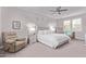 Spacious main bedroom with elegant decor, soft lighting, and a comfortable seating area at 9733 E Axle Ave, Mesa, AZ 85212