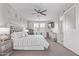Bright and airy main bedroom featuring a luxurious bed, dresser, ceiling fan, and plantation shutters at 9733 E Axle Ave, Mesa, AZ 85212