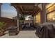Inviting outdoor patio with comfortable seating and a ceiling fan, perfect for relaxing and entertaining at 9733 E Axle Ave, Mesa, AZ 85212