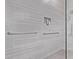 This shower features sleek tile, grab bars, and a convenient recessed niche for toiletries at 9733 E Axle Ave, Mesa, AZ 85212