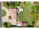 Aerial view of a private backyard with an in-ground pool, spa, mature trees, and a circular driveway at 10532 W Catalina Dr, Avondale, AZ 85392