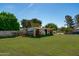 Backyard shed featuring a sturdy structure, providing practical storage space on a spacious lawn at 10532 W Catalina Dr, Avondale, AZ 85392