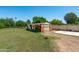 Backyard shed with 'Keep Left' and 'Stop' signs next to a spacious grass area at 10532 W Catalina Dr, Avondale, AZ 85392