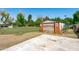 Backyard shed with 'Keep Left' sign, complemented by a concrete area at 10532 W Catalina Dr, Avondale, AZ 85392