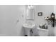 A half bathroom features a pedestal sink, mirror, and fixtures at 10532 W Catalina Dr, Avondale, AZ 85392