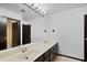 Bathroom featuring dual sinks, a large mirror, and dark wood cabinetry at 10532 W Catalina Dr, Avondale, AZ 85392
