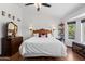Bedroom with wood floors, dresser, and window views of the outdoor landscape at 10532 W Catalina Dr, Avondale, AZ 85392