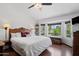 Bright bedroom with wood floors and window views to the greenery outside at 10532 W Catalina Dr, Avondale, AZ 85392