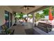 Inviting covered patio equipped with ceiling fans, cozy seating, and an open view of the backyard at 10532 W Catalina Dr, Avondale, AZ 85392