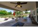 Expansive covered patio offering outdoor seating, ceiling fans, and a view of the green backyard at 10532 W Catalina Dr, Avondale, AZ 85392