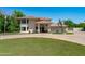 Inviting two-story home featuring an immaculate lawn, a circular driveway, and charming curb appeal at 10532 W Catalina Dr, Avondale, AZ 85392