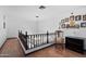 Hallway with dark wooden railing and hardwood floors at 10532 W Catalina Dr, Avondale, AZ 85392