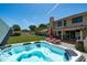 Relaxing hot tub in backyard with a spacious lawn and custom outdoor cooking space at 10532 W Catalina Dr, Avondale, AZ 85392