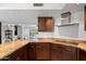 An inviting kitchen features granite countertops, wood cabinets and stainless steel vent hood at 10532 W Catalina Dr, Avondale, AZ 85392
