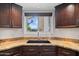 A well-lit kitchen features granite countertops and a window overlooking the yard at 10532 W Catalina Dr, Avondale, AZ 85392