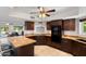 Well-lit kitchen featuring dark wood cabinetry, granite countertops, and stainless steel appliances at 10532 W Catalina Dr, Avondale, AZ 85392
