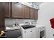 Well-organized laundry room featuring cabinets, washer and dryer at 10532 W Catalina Dr, Avondale, AZ 85392