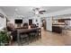 Open-concept living room with tile floors, ceiling fans, and barstool seating at 10532 W Catalina Dr, Avondale, AZ 85392