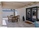 A wooden dining table and chairs are set upon the tiled back patio of the house at 10609 N 32Nd Cir, Phoenix, AZ 85029