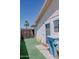 View of a low-maintenance backyard with artificial turf, a block wall, and a view of a palm tree at 10609 N 32Nd Cir, Phoenix, AZ 85029