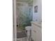 Bathroom featuring a glass enclosed shower with marble tile and gold hardware with vanity and gray floor mat at 10609 N 32Nd Cir, Phoenix, AZ 85029