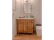 Bathroom features a wooden vanity cabinet, modern mirror, sleek toilet, and stylish beige tile at 10609 N 32Nd Cir, Phoenix, AZ 85029