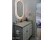 Bright bathroom featuring a lighted mirror, white marble countertop, and gold hardware with a modern design at 10609 N 32Nd Cir, Phoenix, AZ 85029