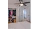 Bedroom featuring a closet with well-organized storage solutions, light wood floors, and ceiling fan at 10609 N 32Nd Cir, Phoenix, AZ 85029