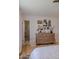 Bedroom with wooden dresser, framed wall art, and ensuite bathroom with marble shower at 10609 N 32Nd Cir, Phoenix, AZ 85029