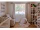 Bright Bedroom featuring a crib, rocking chair, natural light, and playful decor at 10609 N 32Nd Cir, Phoenix, AZ 85029