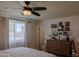 Bright bedroom with a dresser, decorative wall art, and a window with natural light and neutral tones at 10609 N 32Nd Cir, Phoenix, AZ 85029